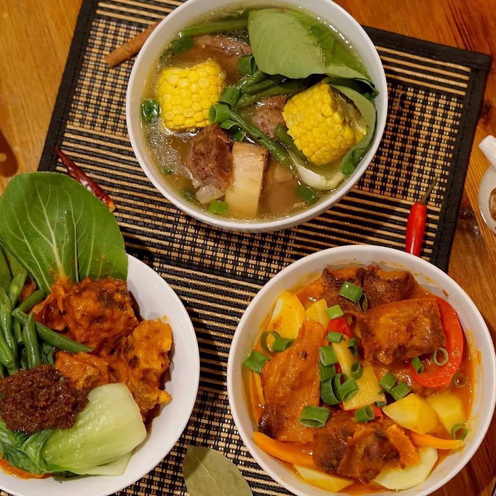 Bowls of bulalo soup with corn and greens, and two hearty stews